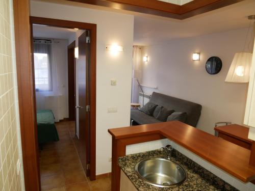 a bathroom with a sink and a living room at Cabirol-Vacances Pirinenca in Incles