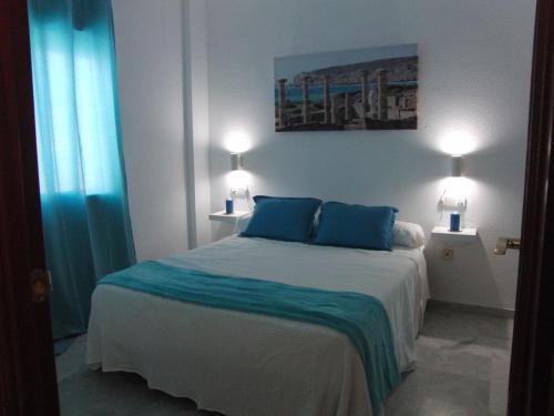 Кровать или кровати в номере Apartamento Junto a El Corte Inglés Algeciras 3