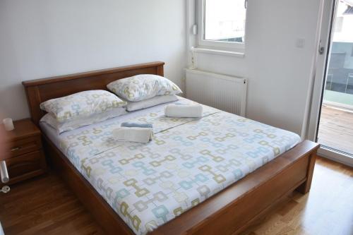 a bedroom with a bed with two pillows on it at Relax Teslić in Teslić