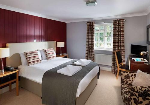 Un dormitorio con una cama grande y una ventana en The White Swan, en Arundel