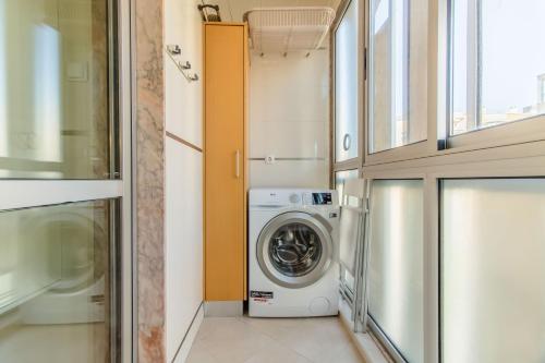 a laundry room with a washer and dryer at Telheiras Comfortable Stay in Lisbon