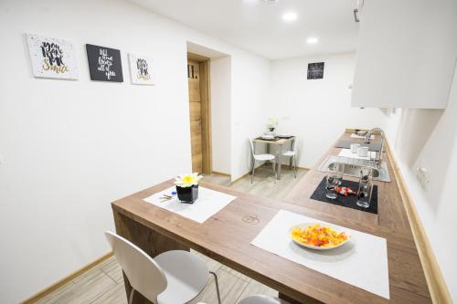 a kitchen with a table and chairs in a room at Guesthouse Urša in Preddvor