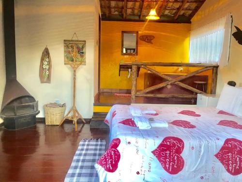 a bedroom with a bed and a fireplace at Pousada Recanto da Siriema in Monte Alegre do Sul