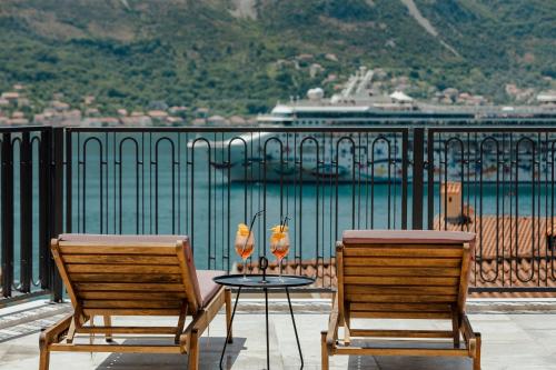 two chairs and a table with two glasses on it at Boutique Hotel Casa del Mare - Vizura in Kotor