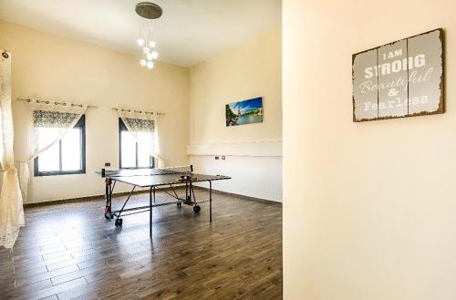 a dining room with a ping pong table in it at Galilee Hills - Resort & Suites in Maghār