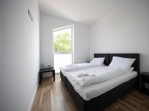 Postel nebo postele na pokoji v ubytování Apartamenty Szlachecki Dwór