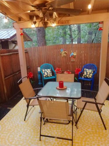 a patio with a table and chairs and a fence at 2BR Gated Escape With A Pool And Walk to Dining and Trails in Pinetop-Lakeside
