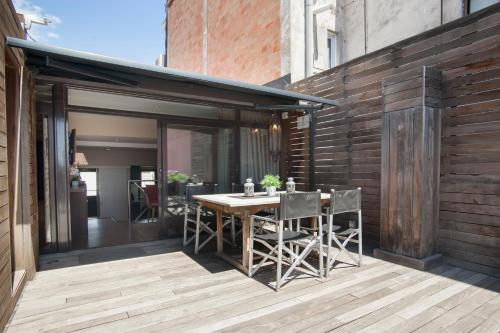 バルセロナにあるテンダンシー アパートメンツ 7の屋外パティオ(木製のテーブルと椅子付)