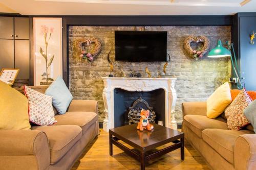 a living room with two couches and a fireplace at Leeson Lane Boutique Townhouse in Dublin
