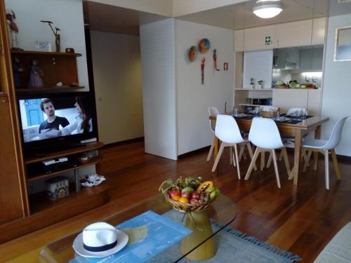 a living room with a kitchen and a dining room at Un Balcon Sur La Mer in Funchal