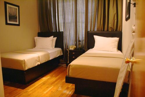 Katil atau katil-katil dalam bilik di Off SoHo Suites Hotel