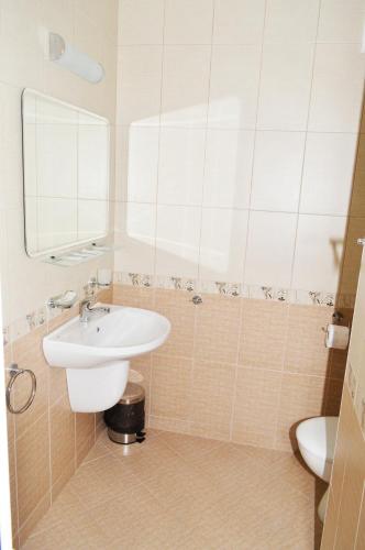 a bathroom with a sink and a mirror at Paradise Hotel & Relax Center in Pomorie