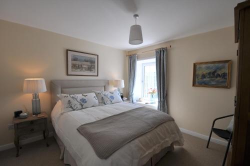 a bedroom with a large bed and a window at No 1 Ramageton at Carnell Estates in Hurlford