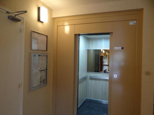 a door leading into a room with a mirror at Appartement Ste Cécile à 50 mètres de la plage in Sainte-Cécile-Plage