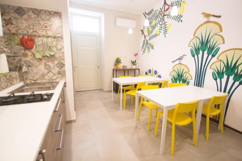 a kitchen with two tables and yellow chairs at Papiroom's in Syracuse