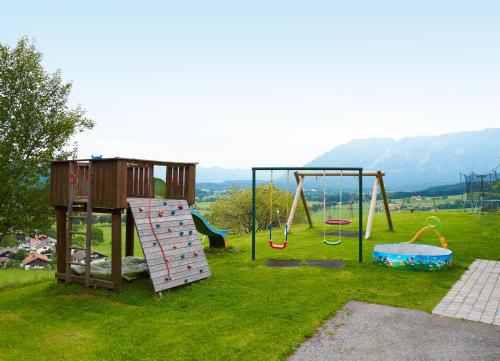 a park with a playground with slides and swings at Hölbinger Alm - Apartments in Anger