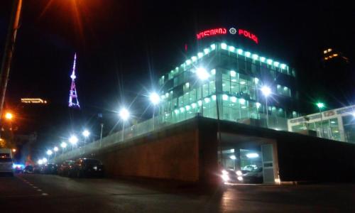 a building with a sign on top of it at night at Terrace House Near Opera in Tbilisi City