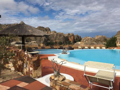 a swimming pool in a resort with a rock formations at Isalo Rock Lodge in Ranohira