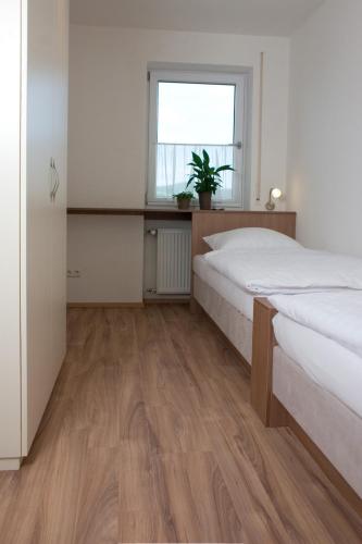 a bedroom with two beds and a window at Hölbinger Alm - Apartments in Anger