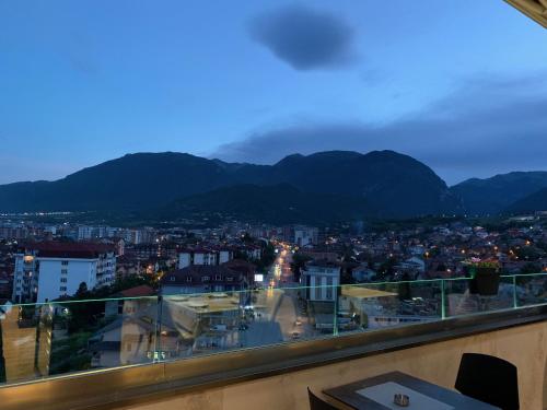 a view of a city with mountains in the background at Kuint Hotel in Peje