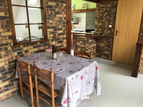 a table with a bottle of wine on top of it at Gîte du ROCHER in Lapoutroie