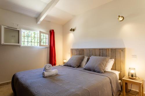 a bedroom with a bed with a towel on it at Mas Saint Julien in Cavaillon