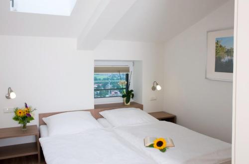 a bedroom with a bed with a sunflower on it at Hölbinger Alm - Apartments in Anger