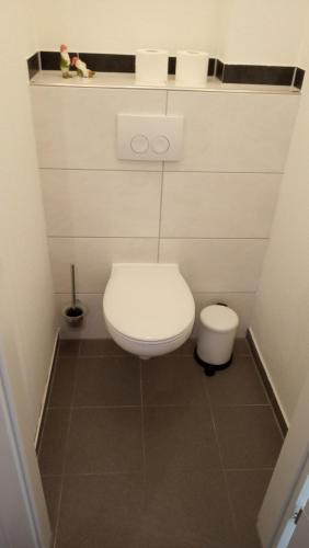 a small bathroom with a white toilet in a room at Haus Harzland in Wernigerode