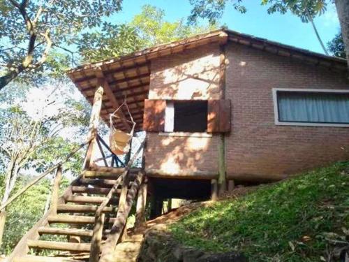 a house with a staircase leading up to it at Pousada Recanto da Siriema in Monte Alegre do Sul