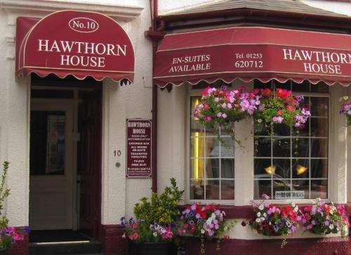 
a store front with flowers on the front of it at Hawthorn House in Blackpool
