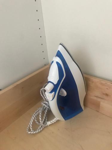 a blue and white blow dryer sitting on a floor at Grazer Schwalbe in Graz