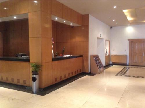 a lobby with a bar in a building at Hotel Sevilla in Mexico City
