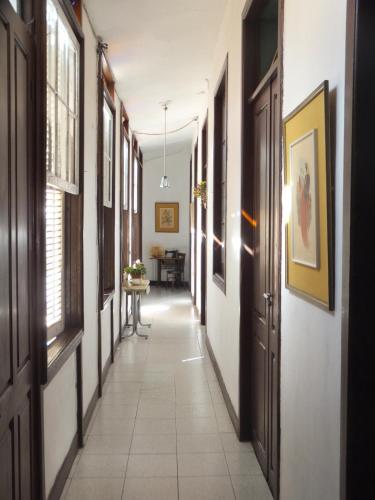 a hallway with white walls and windows and a table at PENSION CEJAS Casa Colonial Cejas in Santa Cruz de Tenerife