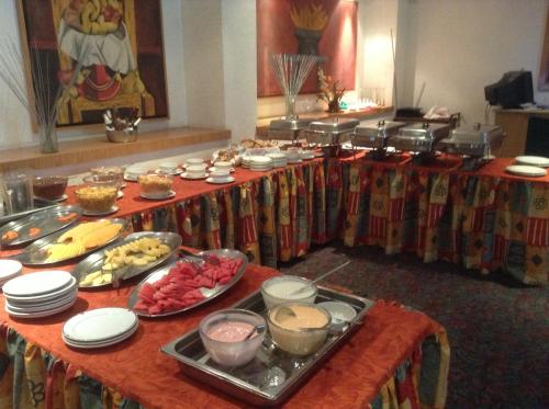 a buffet of food on a table in a room at Hotel Sevilla in Mexico City