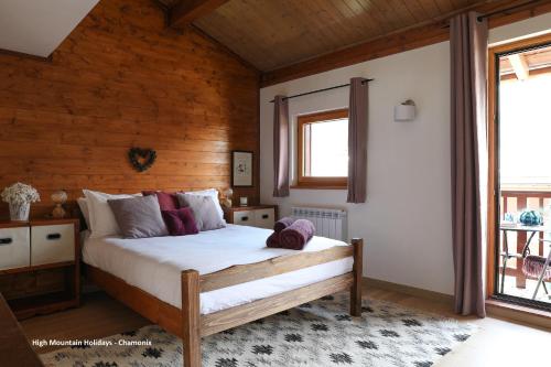 a bedroom with a bed in a room with wooden walls at Apartment Chloe in Chamonix