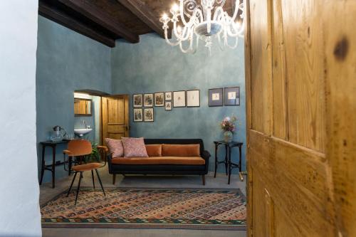 a living room with a couch and a table at Goldenstern Townhouse in Bolzano