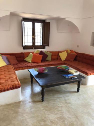a living room with a couch and a coffee table at Dammuso Gaetani in Pantelleria