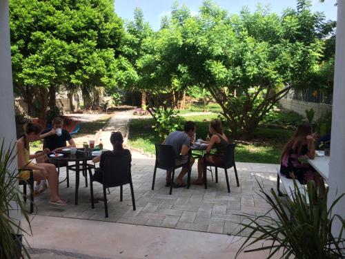 a group of people sitting around tables on a patio at Gran Jaguar Hotel in Bacalar