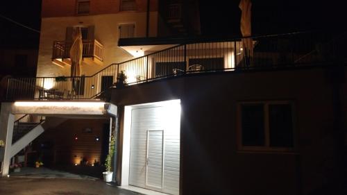 a building with a white garage door at night at Agritur Piccolo Fiore B&B in Taio
