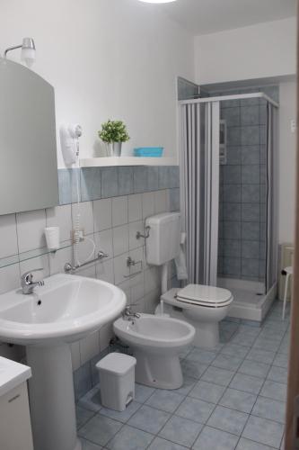 a bathroom with a sink and a toilet and a shower at AFFITTACAMERE LA TRAVERSA in San Cataldo