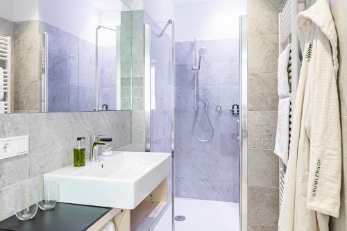 a bathroom with a sink and a shower at Hotel Drumlerhof in Campo Tures