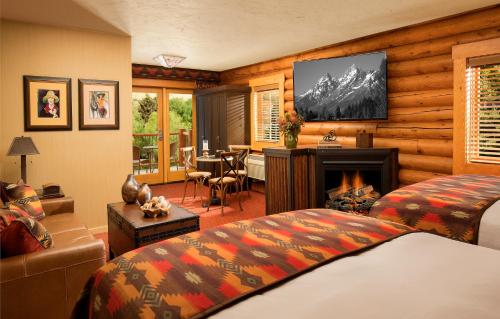 a bedroom with a bed and a fireplace at Rustic Inn Creekside in Jackson