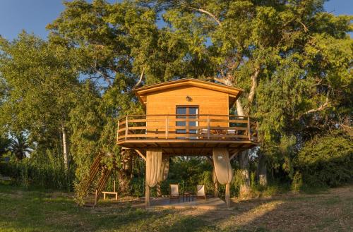 a tree house in the middle of a field at River TreeHouse in Laganas