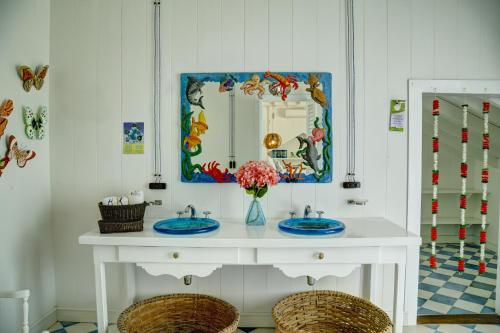 a bathroom with two sinks and a mirror at Hotel Agua Azul Beach Resort in Baru