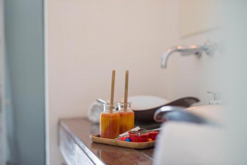 a kitchen counter with a sink with two bottles of liquid at Mas Sainte Marie ,Piscine Chauffée in Aigues-Mortes