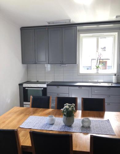 a kitchen with a wooden table and a dining room at Lindens Bed&Breakfast in Mellerud