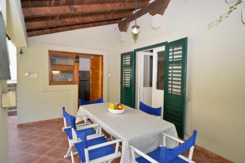ein Esszimmer mit einem Tisch und blauen Stühlen in der Unterkunft Apartments Kriva Ulica in Kotor