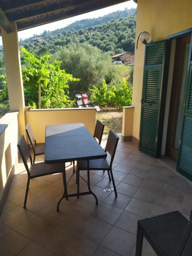 a table and chairs on a patio with a view at Le Ortensie in Dolceacqua