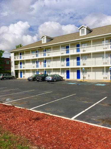 a large building with cars parked in a parking lot at InTown Suites Extended Stay North Charleston SC - Rivers Ave in Charleston