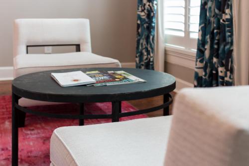 a room with two chairs and a table with a book on it at The Germantown Inn in Nashville